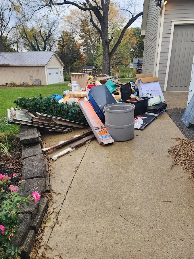 Dumpster being loaded with debris for Estate Cleanout Dumpster Rental in Newtown